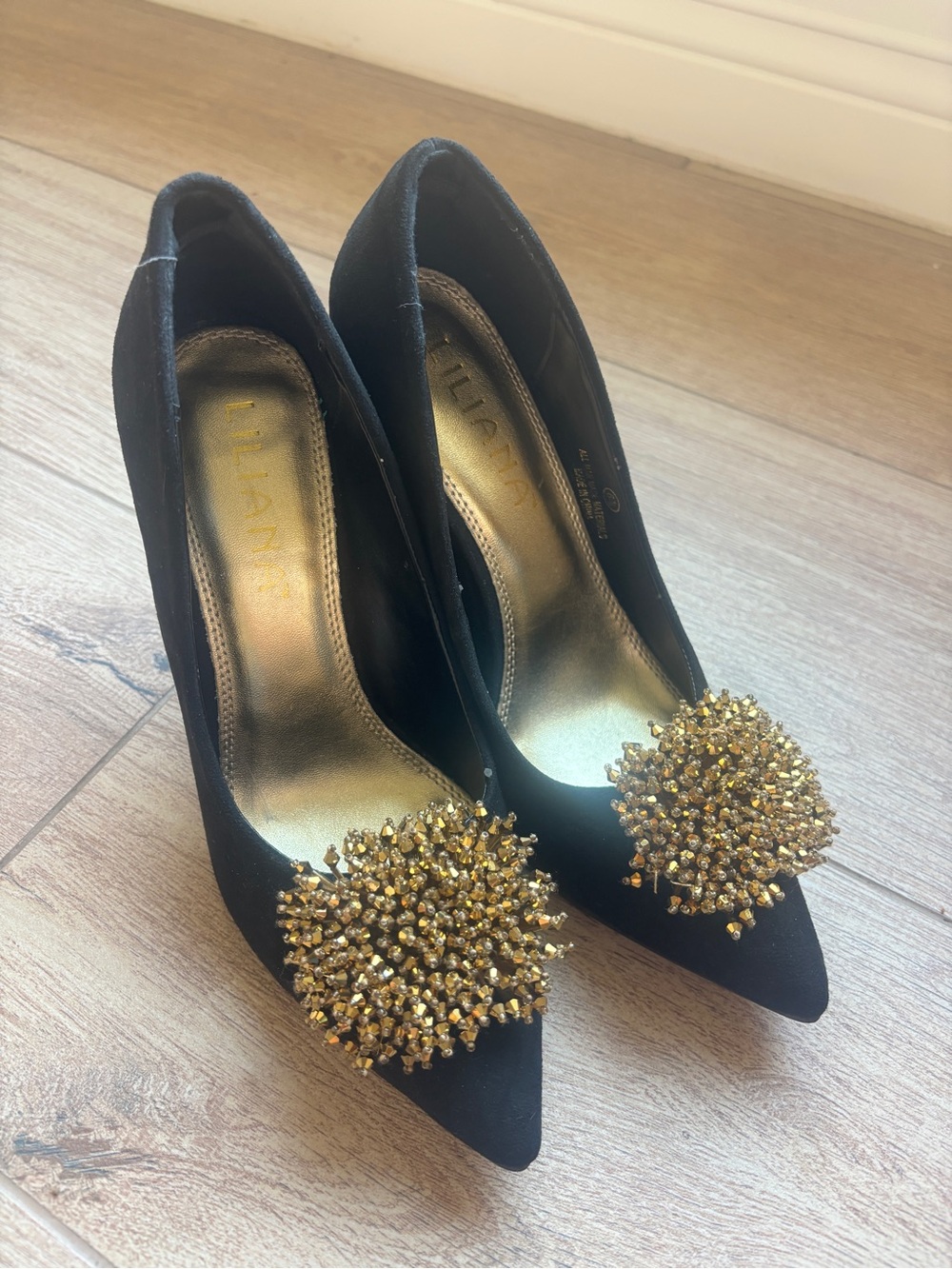 Liliana Black Pointed-Toe Pumps with Gold Crystal Cluster